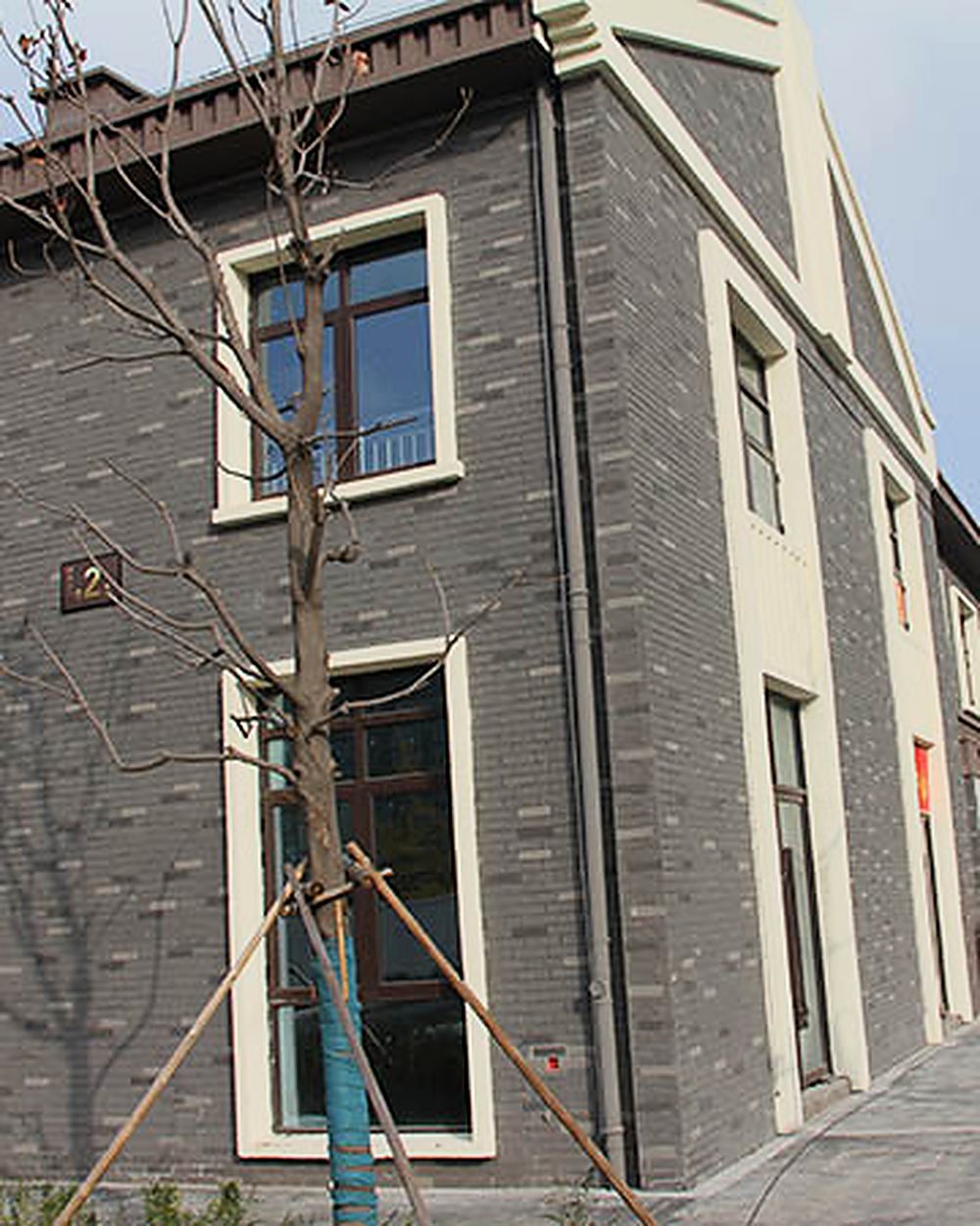 Street of buildings refinished in grey MCM brick texture